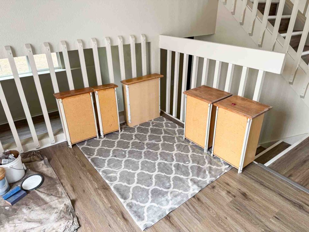 a staircase with a white railing and wooden floor