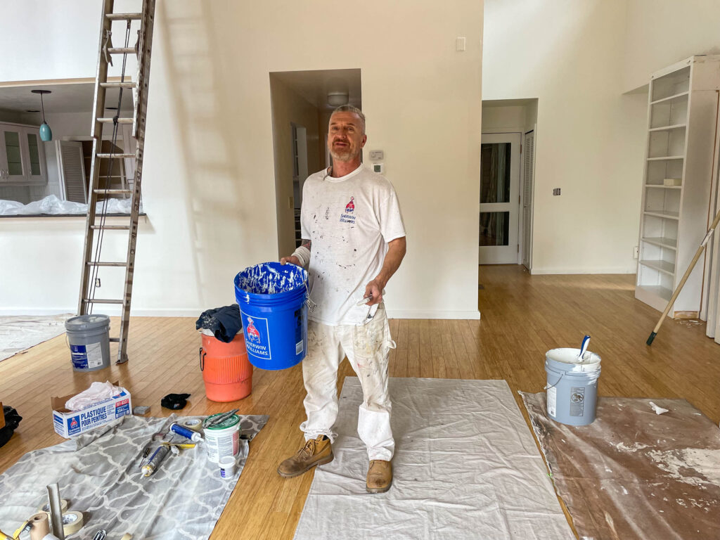 A man with a painting bucket